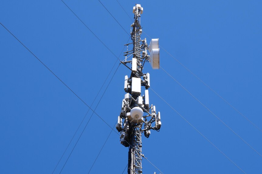 The top of a telephone tower in regional Australia on a blue sky day