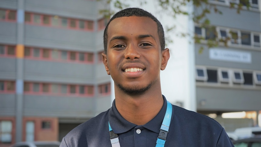 A man standing outside a high rise building.