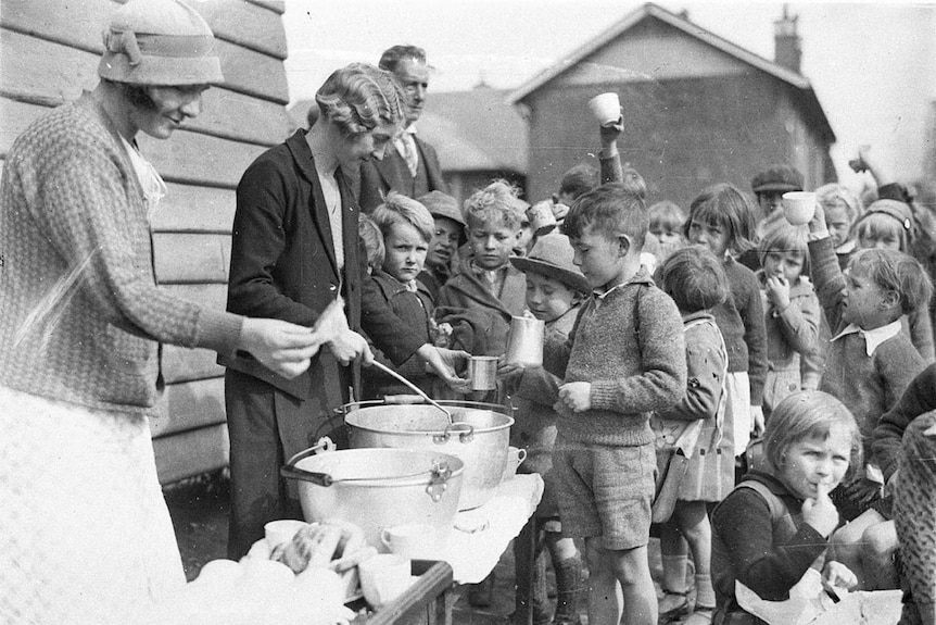 School children line up for free soup and bread during the Great Depression.
