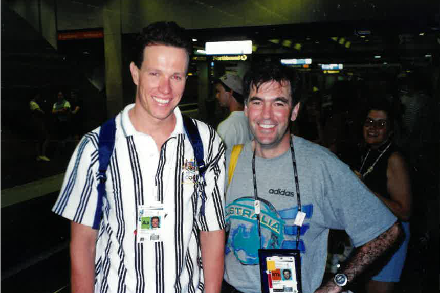 Gee and Perkins standing next to each other at train station.