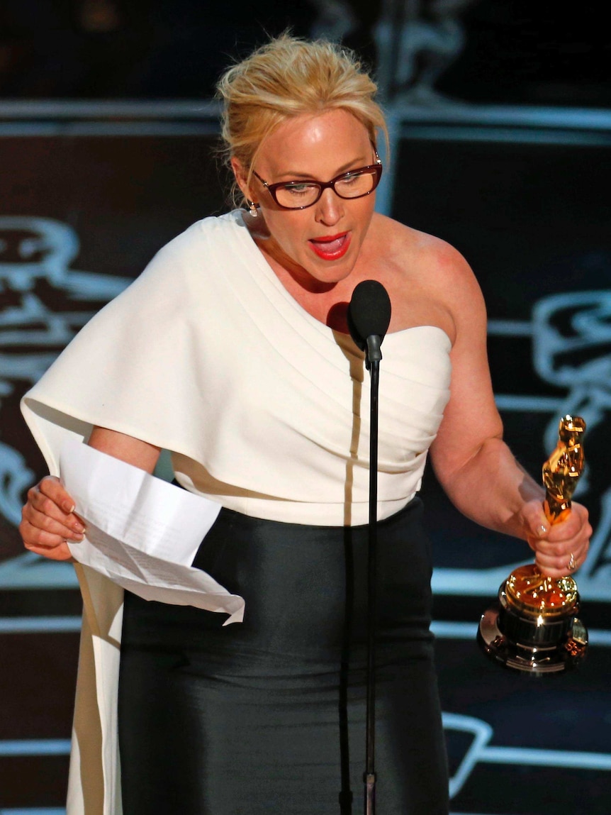 Patricia Arquette accepts her Oscar for best supporting actress at the Academy Awards