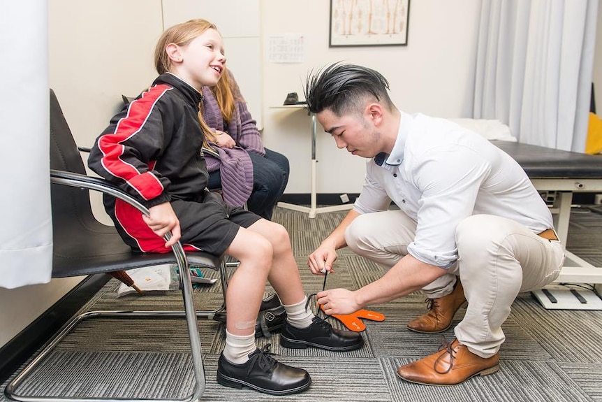 Podiatrist fitting school shoes