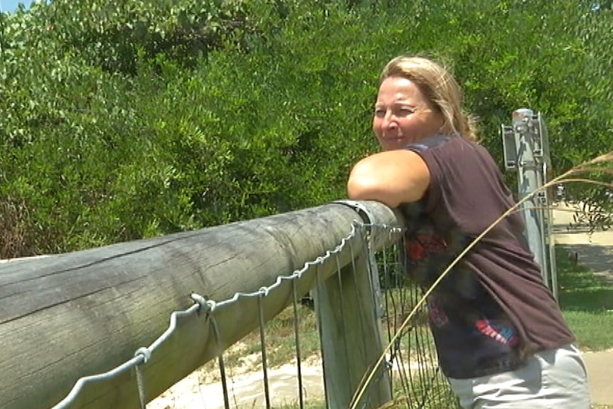 Bilinga resident Diana Gillies looks over dunes where homeless people are setting up camp