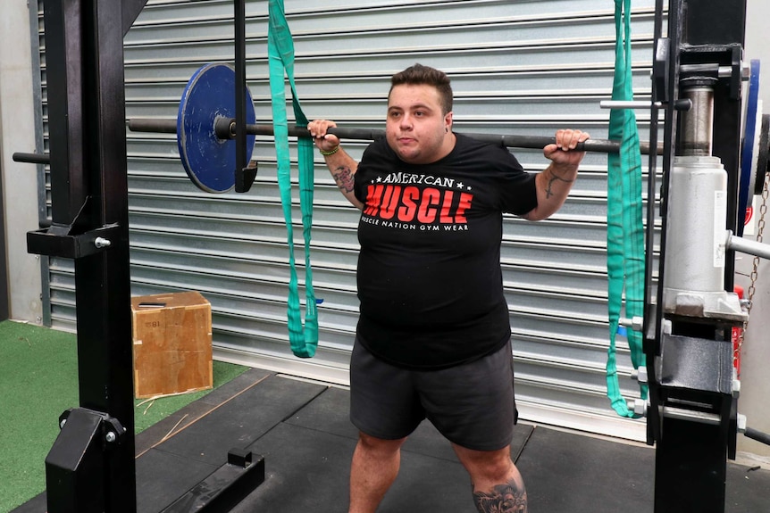 Beau Driscoll finishes a squat at his gym, The Strength Haven, in Cranbourne