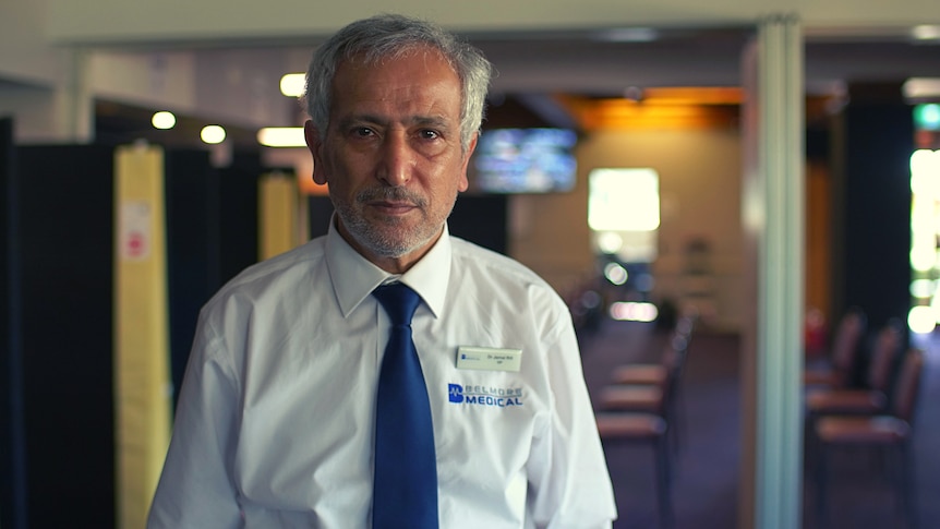 A portrait of a doctor who wears white business shirt and blue tie