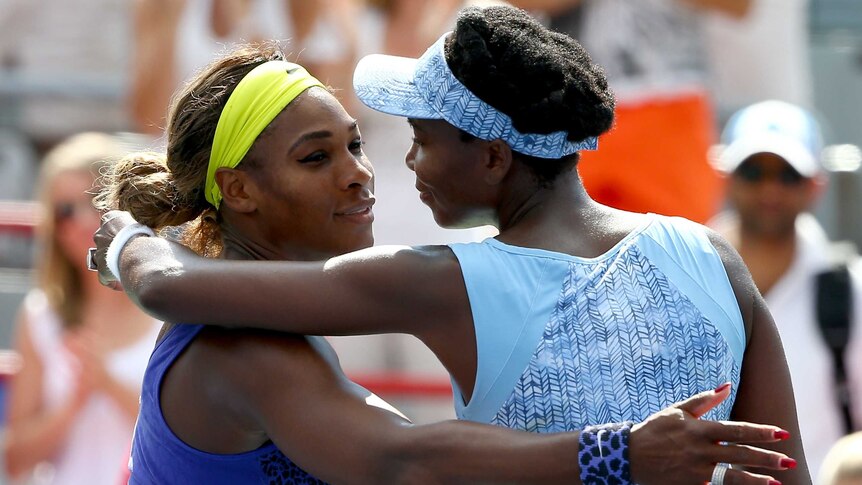 Venus Williams embraces Serena in Montreal