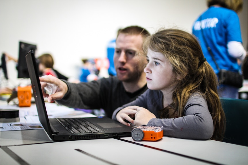 Lucy, 7, with new mentor computer teacher Angus Mc Pherson, are building a website.