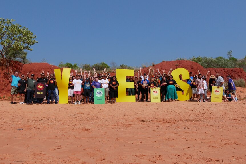A group of around 50 people holding large letters 'Y', 'E' and 'S'.