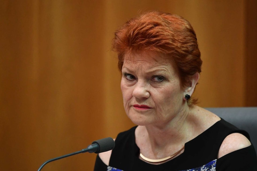 A woman with red hair looks dejected.