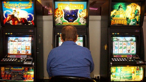 a man playing the poker machines