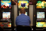 a man playing the poker machines
