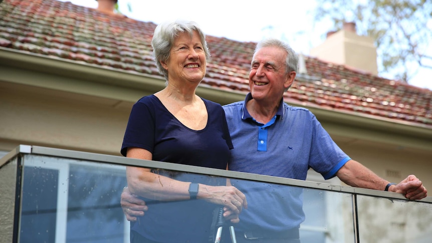 Vanessa and Bruce Fanning laugh on the deck at their Canberra home.