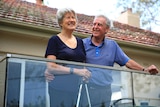 Vanessa and Bruce Fanning laugh on the deck at their Canberra home.