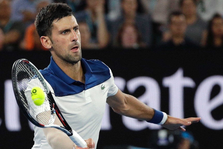Novak Djokovic hits a forehand return during the fourth round match at the Australian Open.
