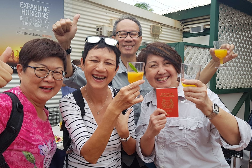 Passengers from the first Perth-Singapore flight mingle at Broome Airport.