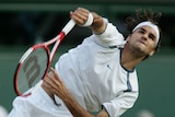 Roger Federer sends down a serve against Juan Carlos Ferrero