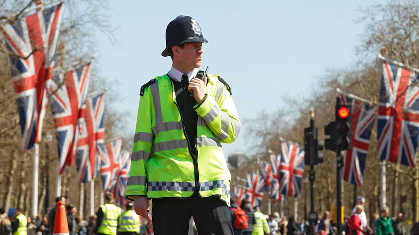 Police officer patrols the Mall day before the London Marathon