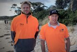 Tasmanians Zeb Critchlow and Tyler Hollmer-Cross standing on a beach.