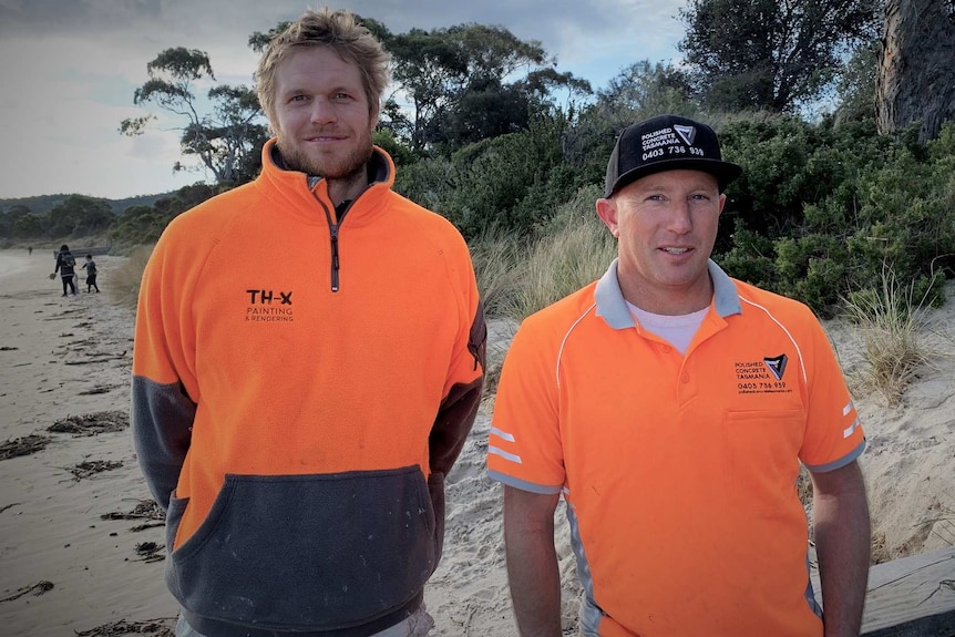 Tasmanians Zeb Critchlow and Tyler Hollmer-Cross standing on a beach.