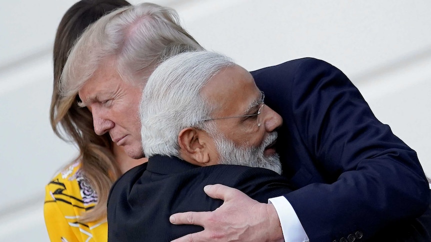 India's Prime Minister Narendra Modi embraced US President Donald Trump on the tarmac.