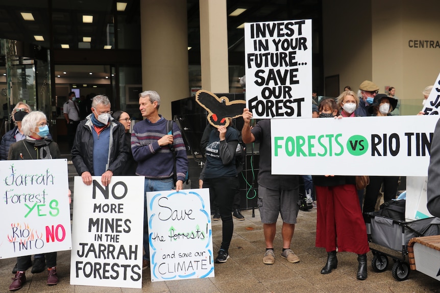 People protest outside a building