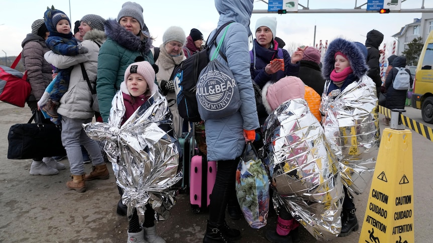 Refugees stand in a group after fleeing the war from neighbouring Ukraine 