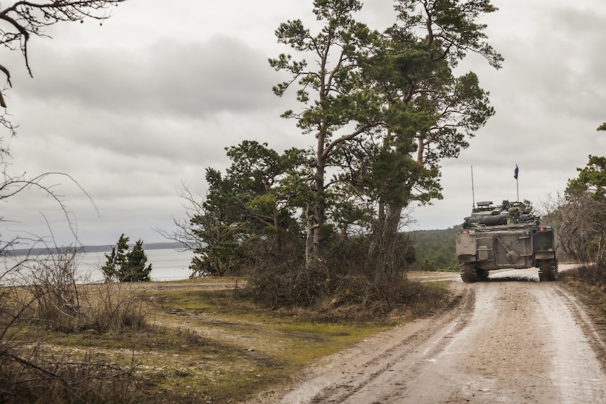 A tank from the Swedish army patrols a gravel road on the island of Crete.