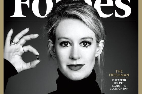 Elizabeth Holmes holds up a small vial of blood on a Forbes magazine cover.