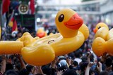 Demonstrators move inflatable yellow rubber ducks during a rally in Bangkok.