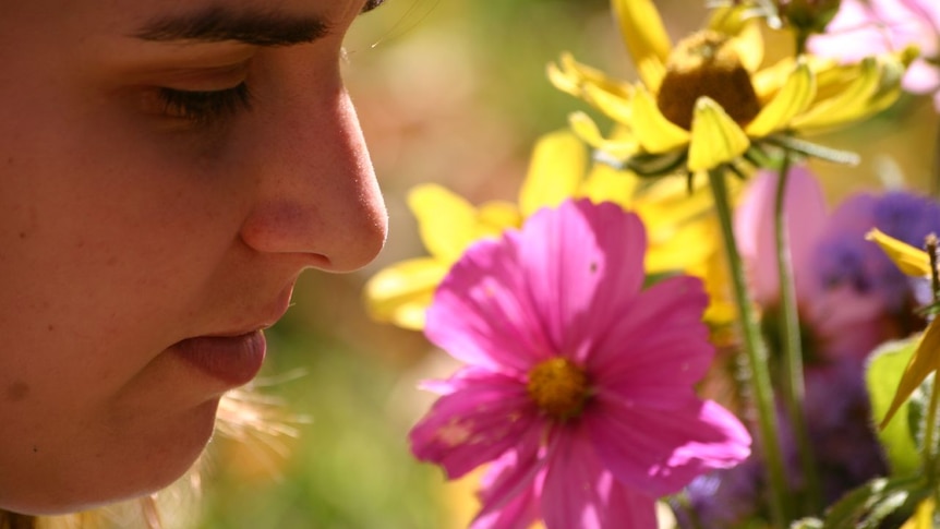 Girl smelling flowers