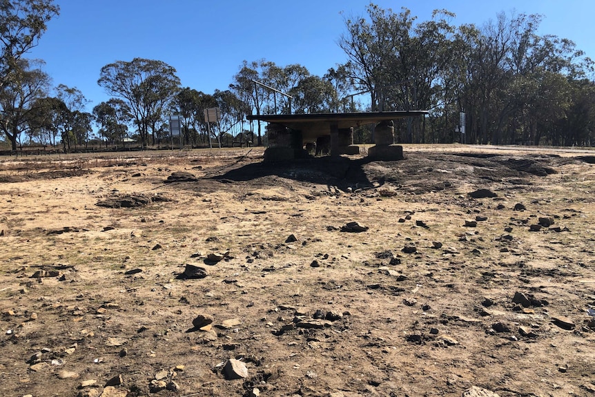 A jetty into a dry bed where town's water supply is meant to be.