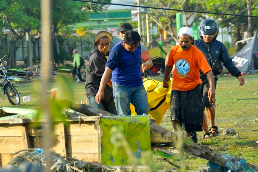 Body bags are left in the streets as rescue workers struggle to reach all the dead.