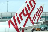 A close-up shot of two Virgin aircraft at an airport.