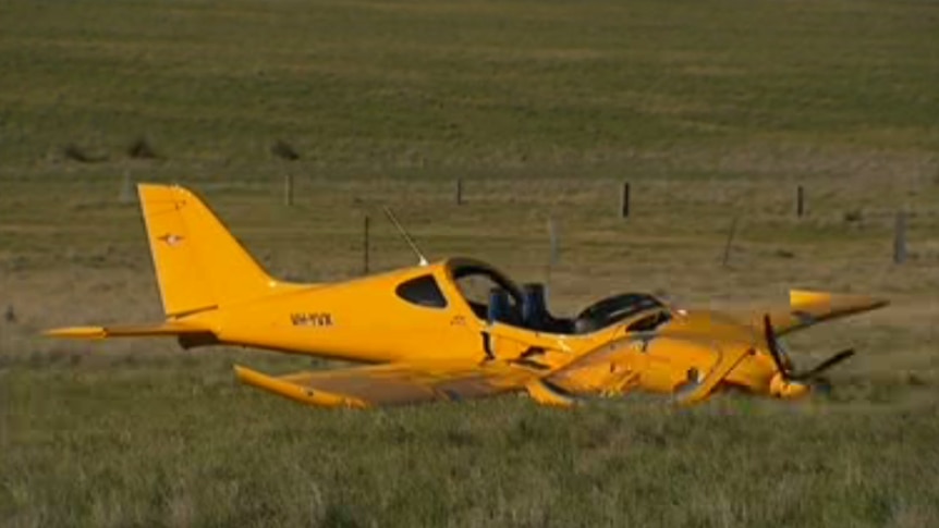 A crashed orange plane in a paddock