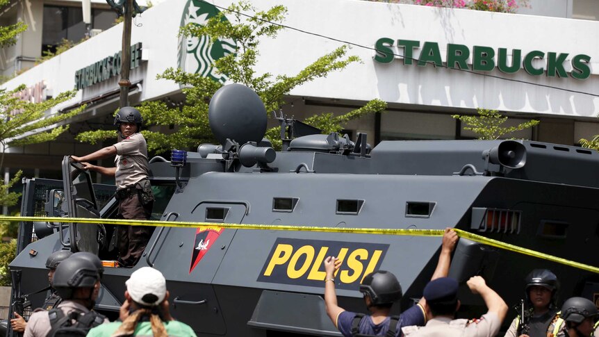 Armoured personnel carrier parked outside Starbucks.