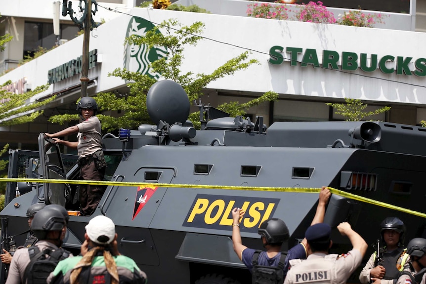 Armoured personnel carrier parked outside Starbucks.