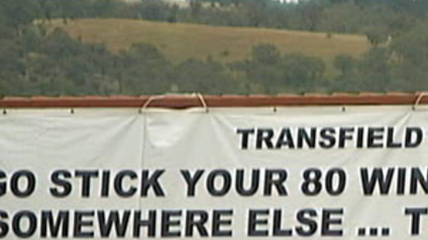 Collector residents opposed to the wind farm have erected a billboard alongside the Federal Highway highlighting their opposition.