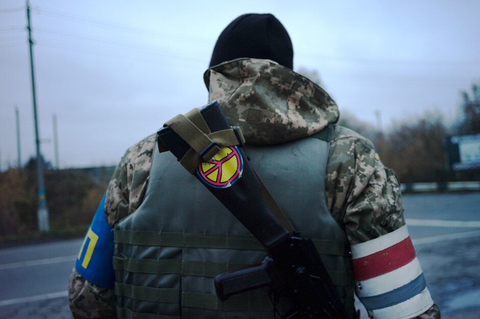 A member of the Ukrainain military police mans a traffic checkpoint in Donetsk leading to Mariupol.