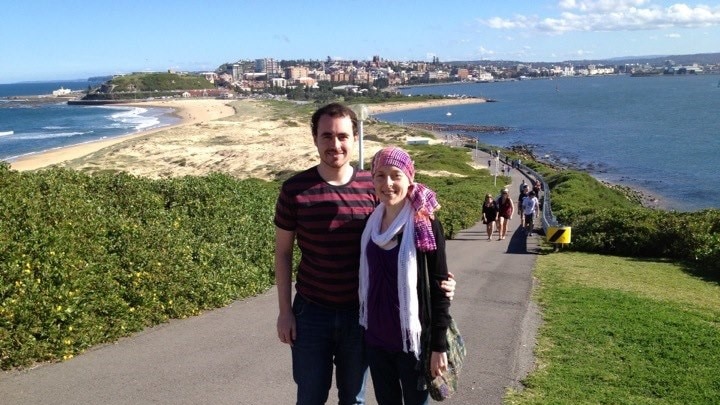 Hannah Perkins wearing a headscarf and walking with her brother in Newcastle.