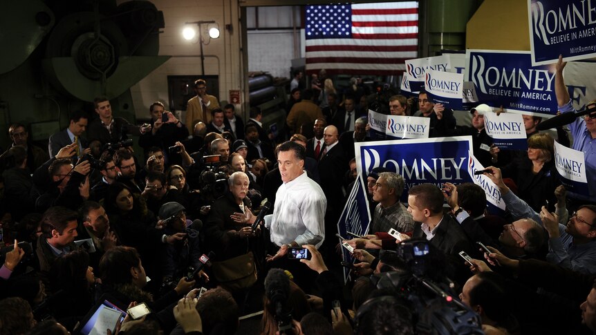 Mitt Romney talks to the press after addressing a speech at Gilchrist Metal Fabricating in Hudson, New Hampshire