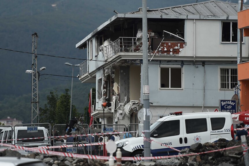 A police car stands outside the destroyed police station in the Sultanbeyli district in Istanbul