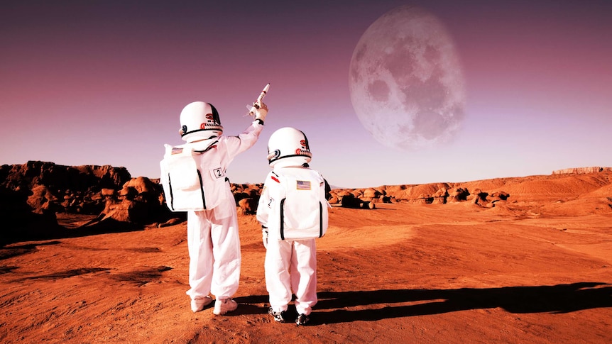 Children dressed as astronauts walking on red earth