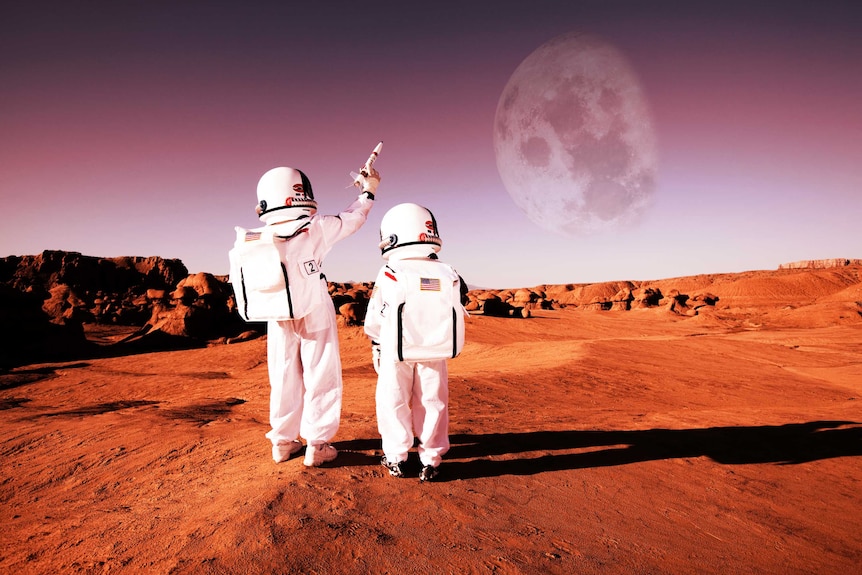Children dressed as astronauts walking on red earth