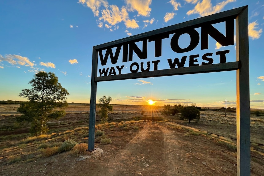 Sun setting behind the Winton Way Out West Festivals sign.