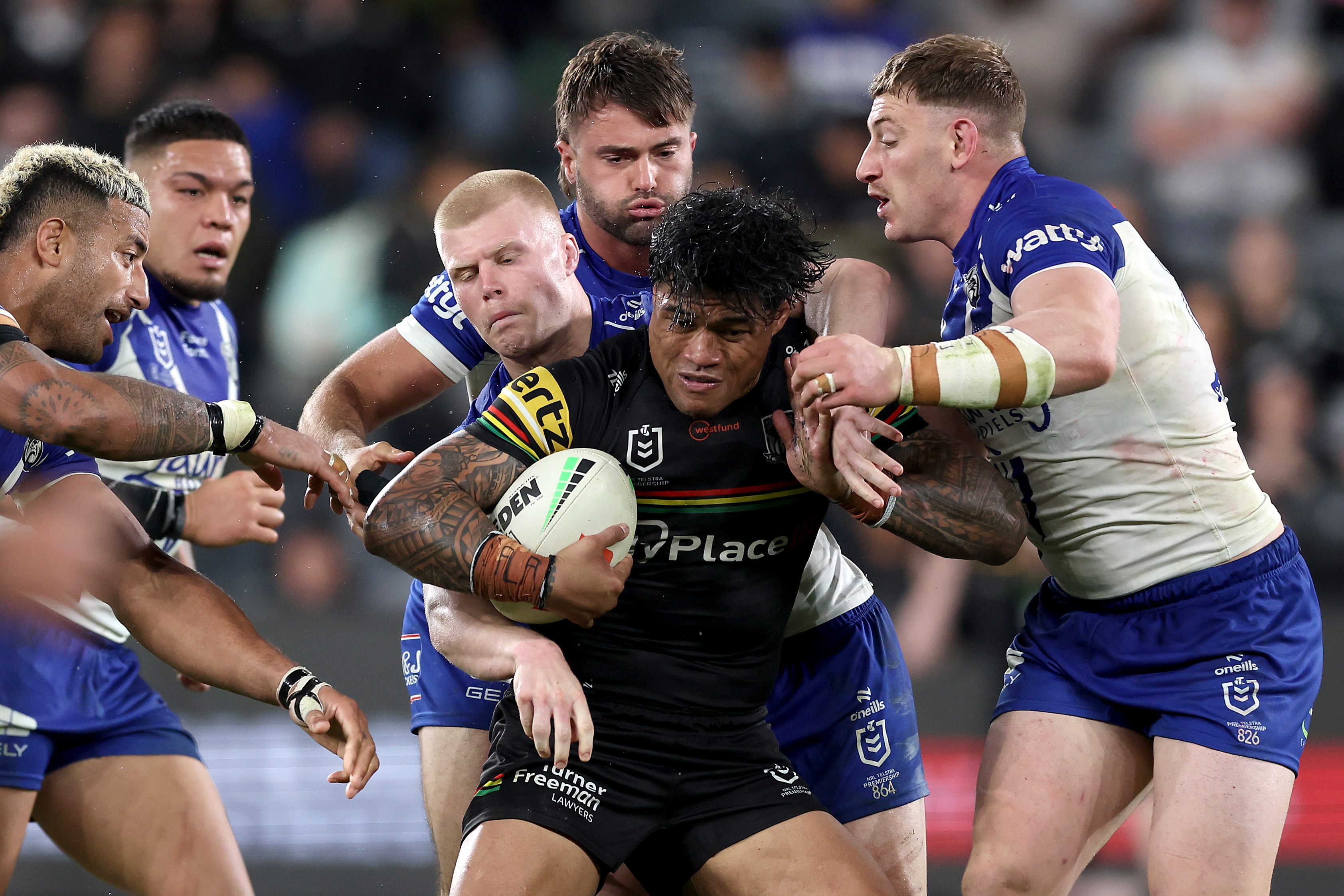 A man runs the ball during a rugby league match