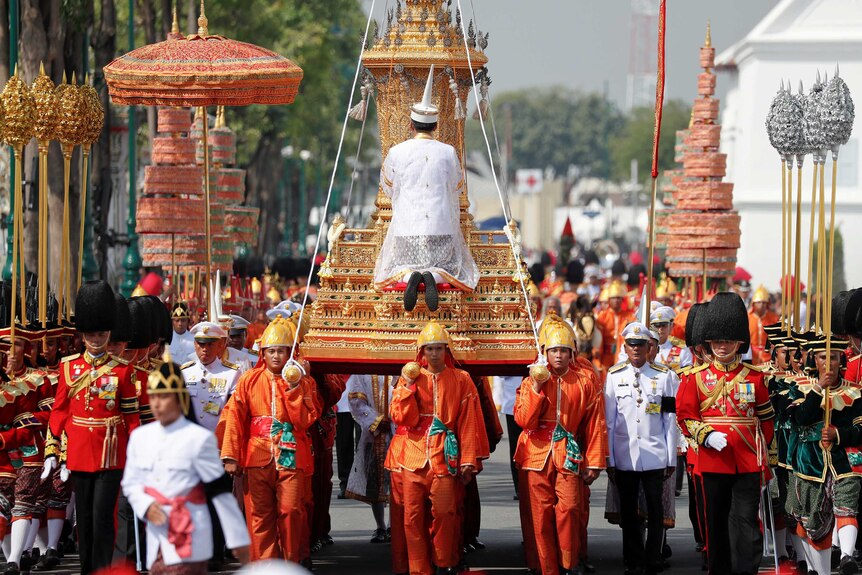 The Royal Urn of Thailand's late King Bhumibol Adulyadej being carried through a crowded street as part of procession.