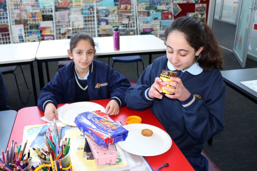 Sara Manjeh sniffs a jar of Vegemite during her school's integration class.