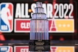 The NBA All-Star Game trophy sits in front of a league logo
