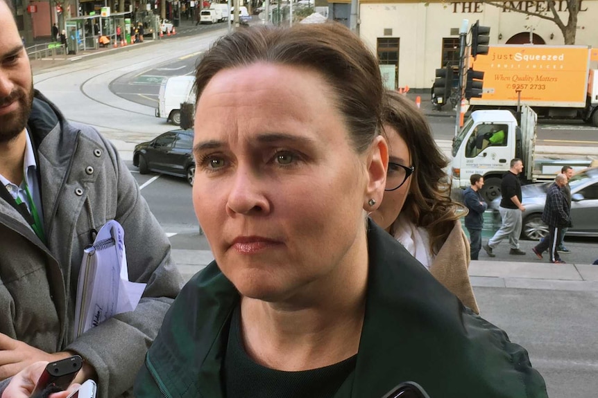 Jane Garrett speaks to reporters on the steps of Parliament House.