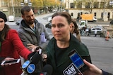 Jane Garrett speaks to reporters on the steps of Parliament House.